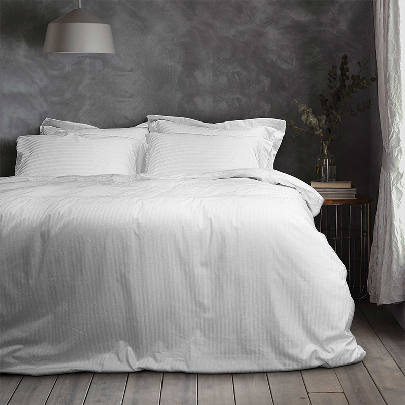 How does the striped design of Cotton T300 1cm striped white hotel bedding sheets match the hotel interior?